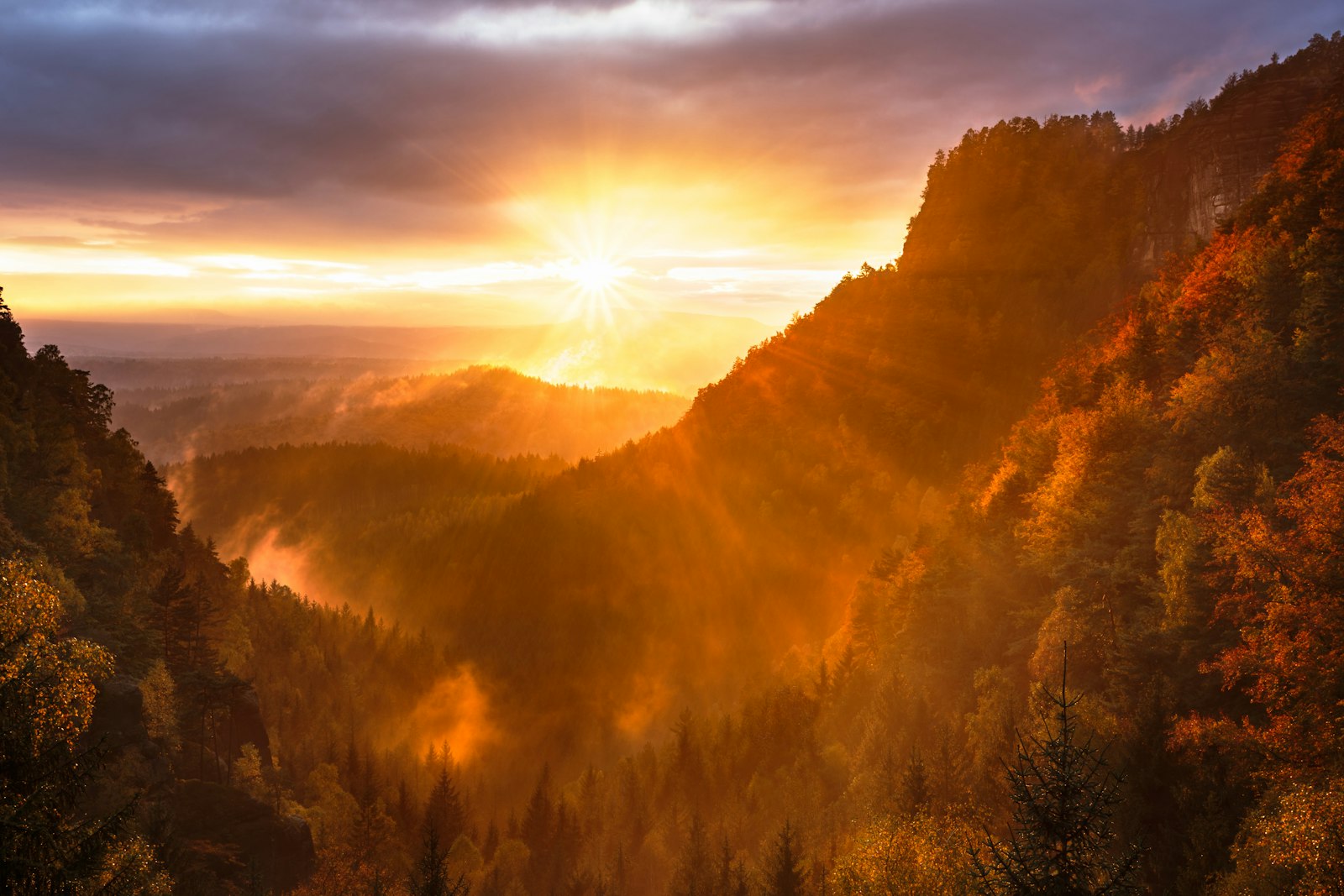 Golden hour sun over a mountain valley