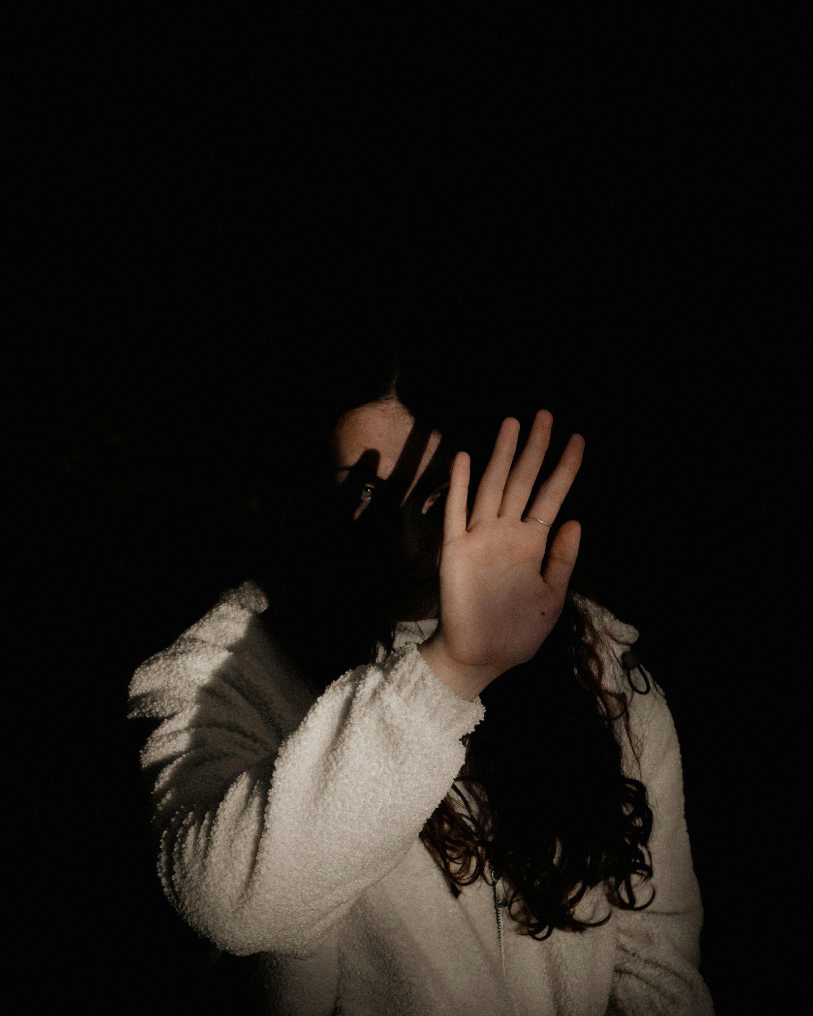 Face lit with hard directional light and deep shadow